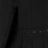Close-up of a black garment with decorative trim on a dark background